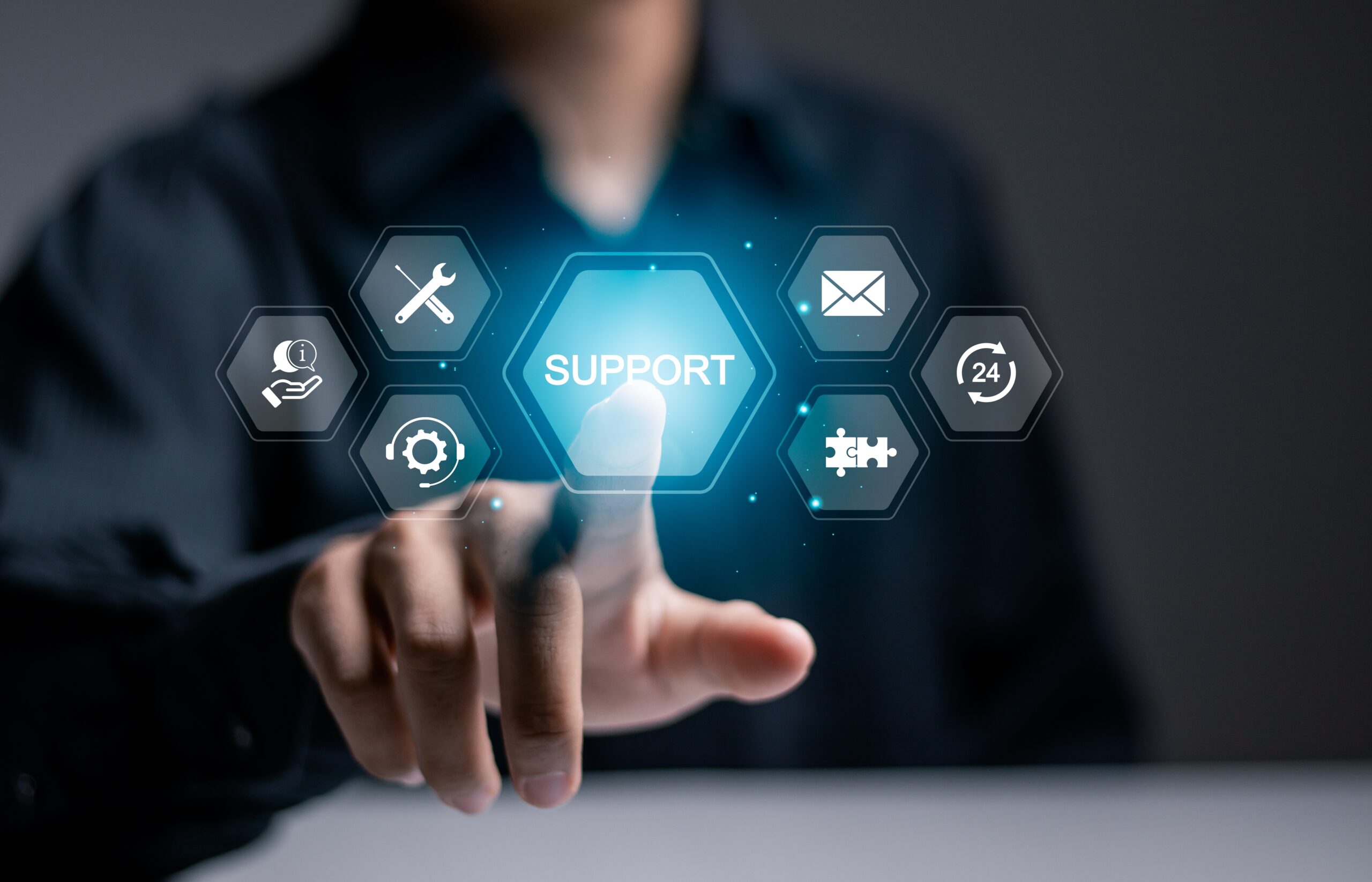 A hand reaches toward a glowing "SUPPORT" icon surrounded by symbols representing various support services, illustrating customer support options.