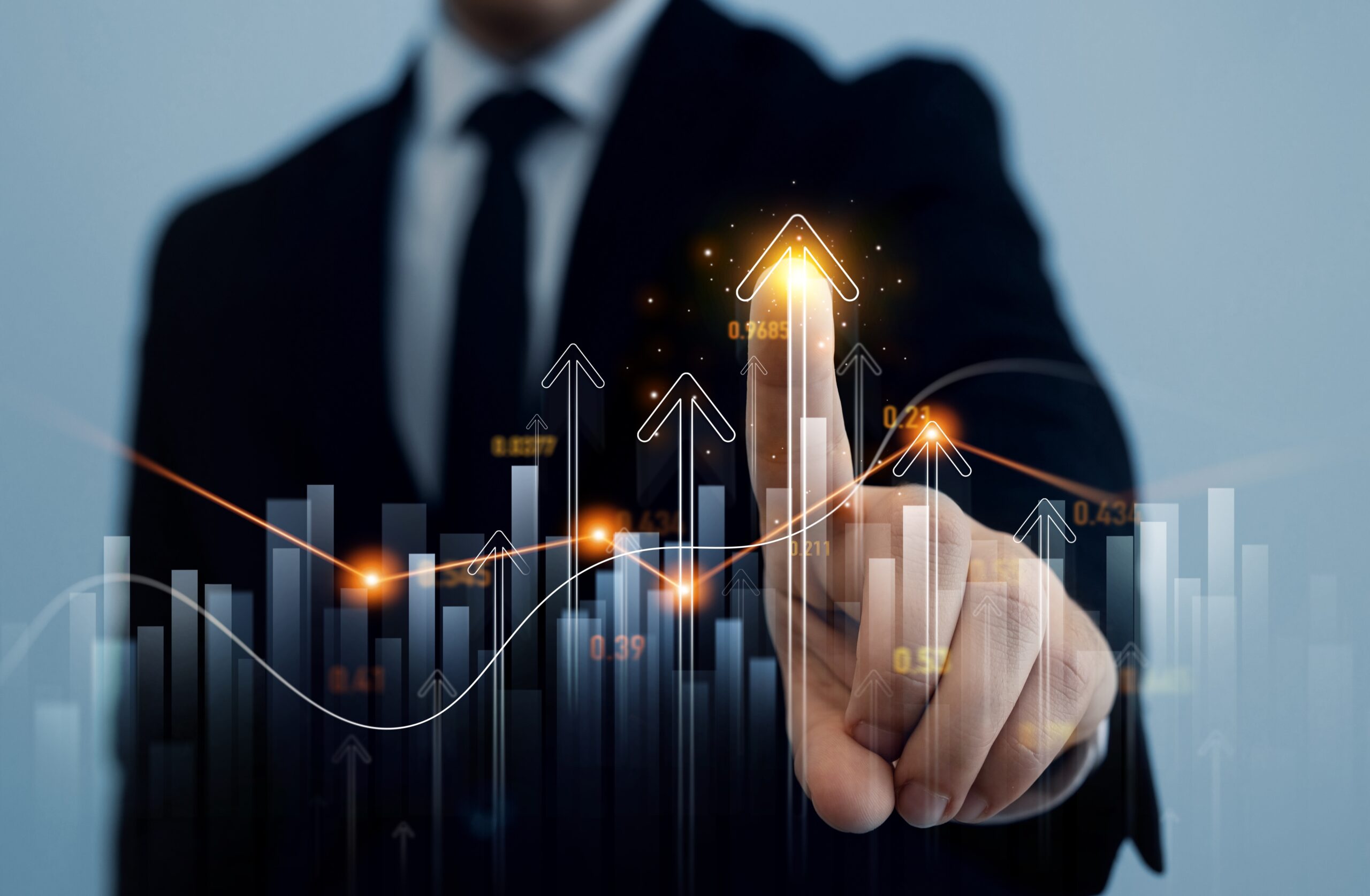 A business professional gestures towards upward-trending financial graphs and data visualizations, symbolizing growth and success.