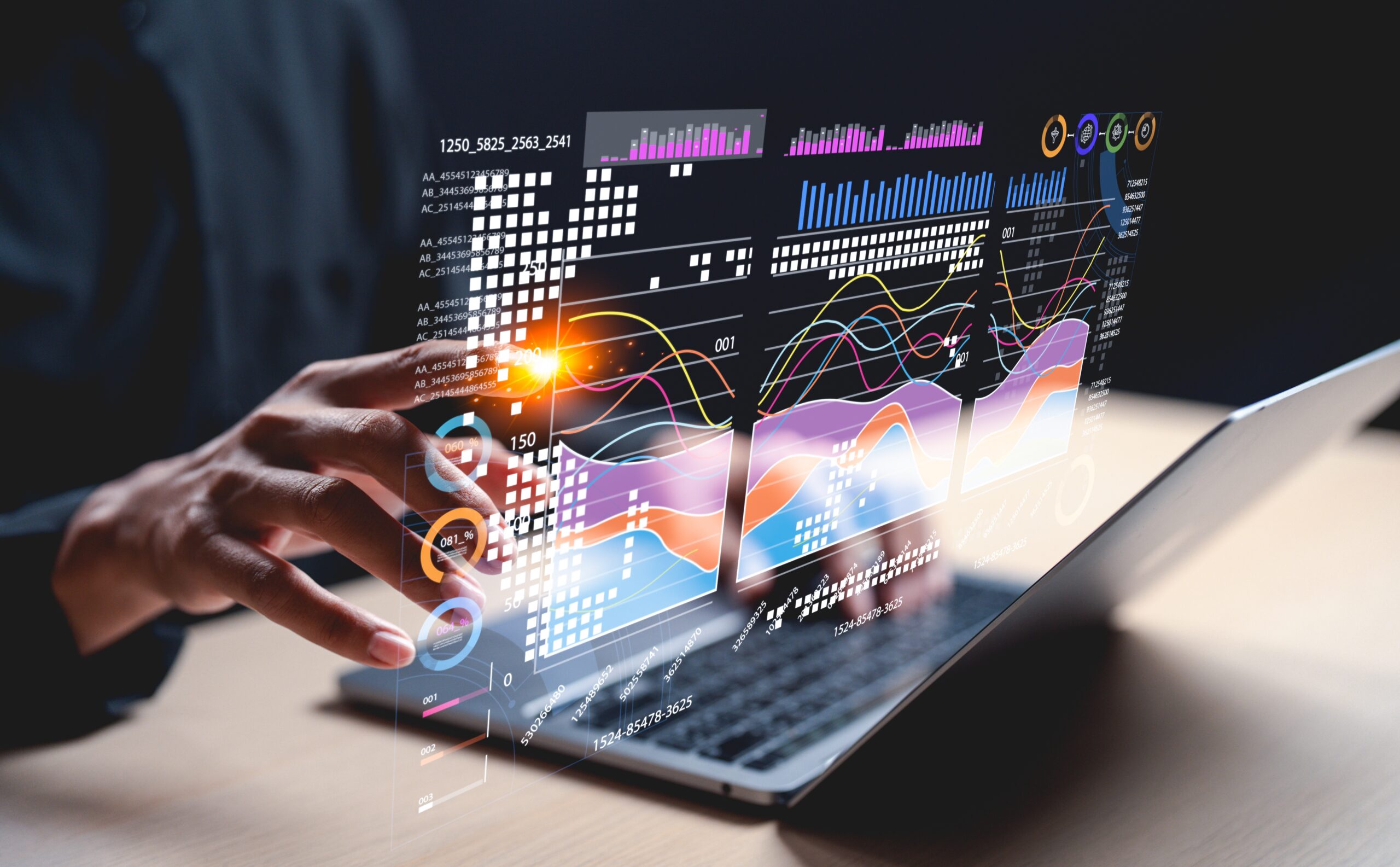 Digital data visualization displays vibrant graphs and charts on a laptop, with a person interacting via touch. Emphasizes data analysis and technology.